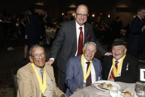 President C. L. Max Nikias with a group of trojan WWII veterans who were honored at the event. From L-R Richard Vivian ’45, Pete Caggiano (great grandfather of a current USC ROTC student), Bruce Kaji ’50. (Photo/Steve Cohn)